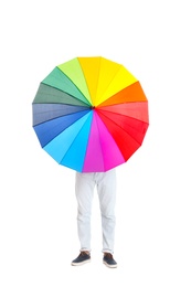 Photo of Man hiding behind rainbow umbrella on white background