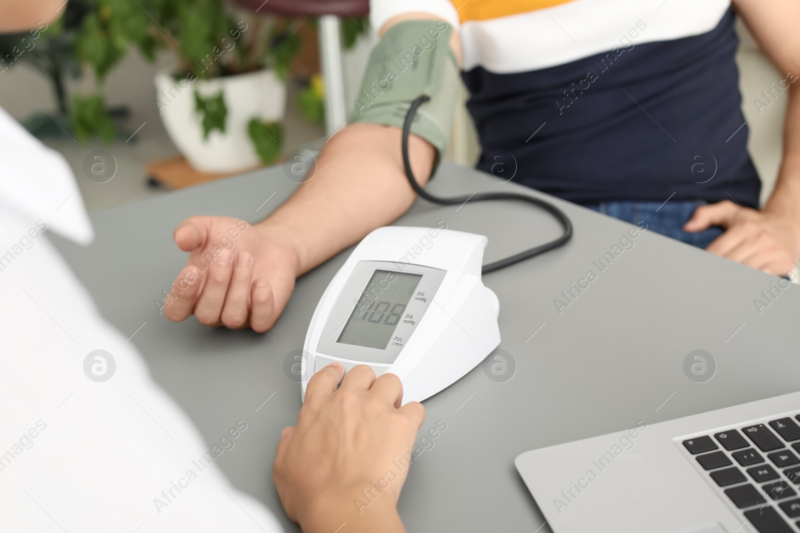 Photo of Doctor checking patient's blood pressure in hospital