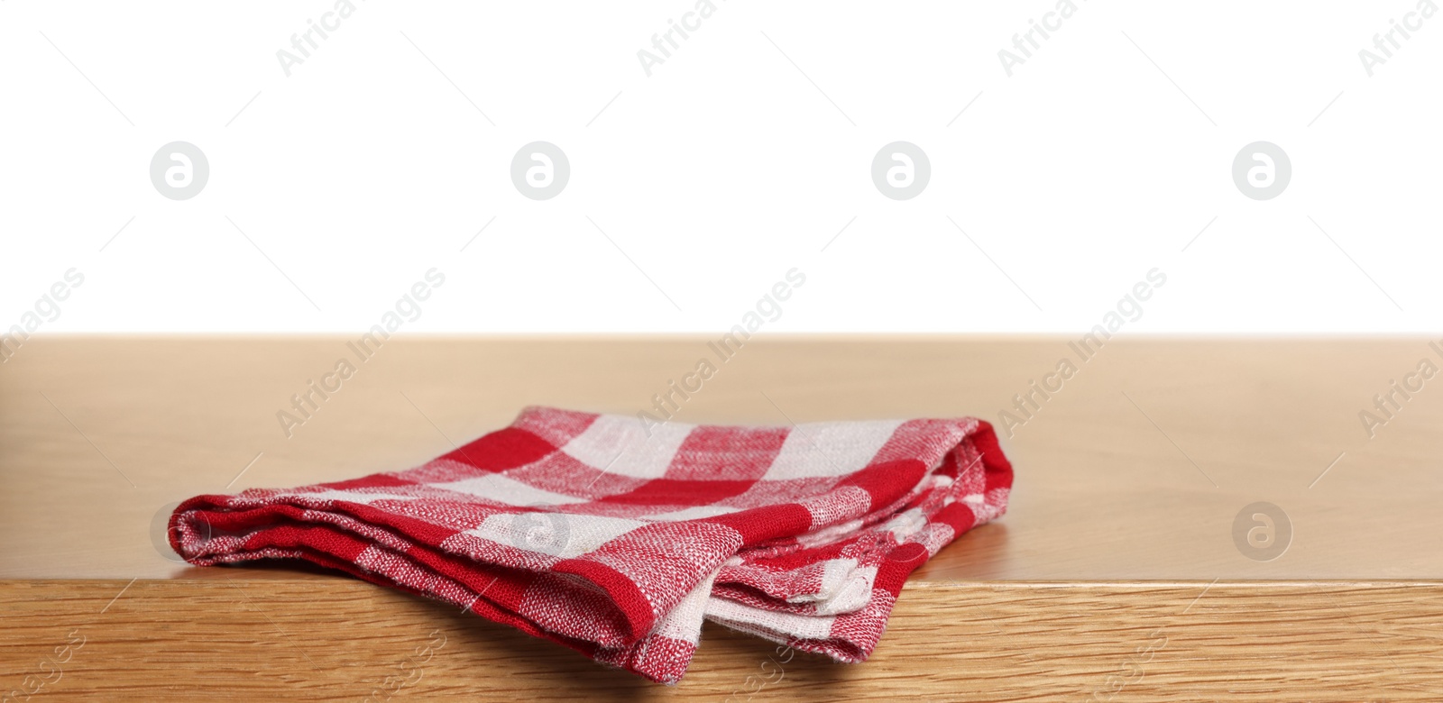 Photo of Checkered tablecloth on wooden table against white background