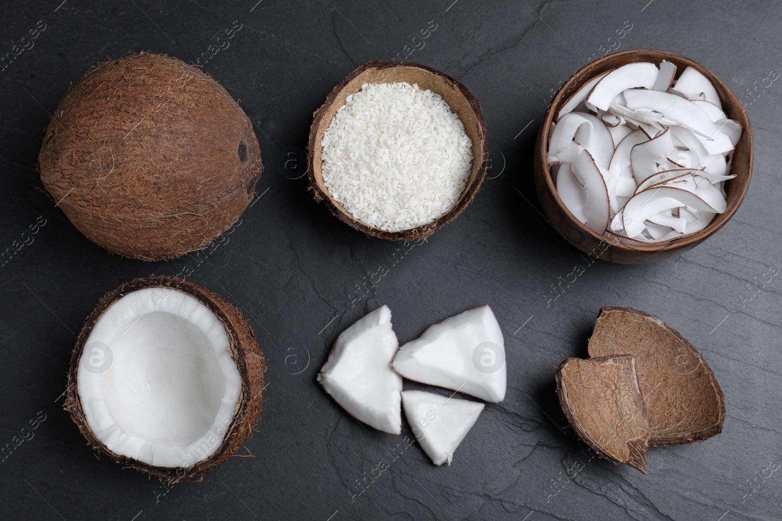 Photo of Flat lay composition with fresh coconut flakes on black table