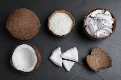 Photo of Flat lay composition with fresh coconut flakes on black table