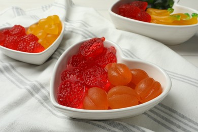 Photo of Delicious gummy fruit shaped candies on table
