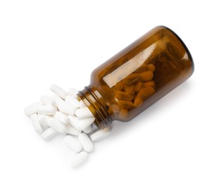 Photo of Bottle and vitamin pills isolated on white, top view