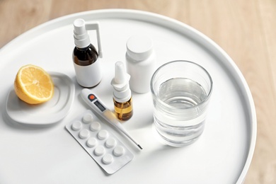 Photo of Lemon, pills and drugs for cold on table