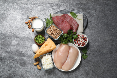 Photo of Products rich in protein on grey table, flat lay