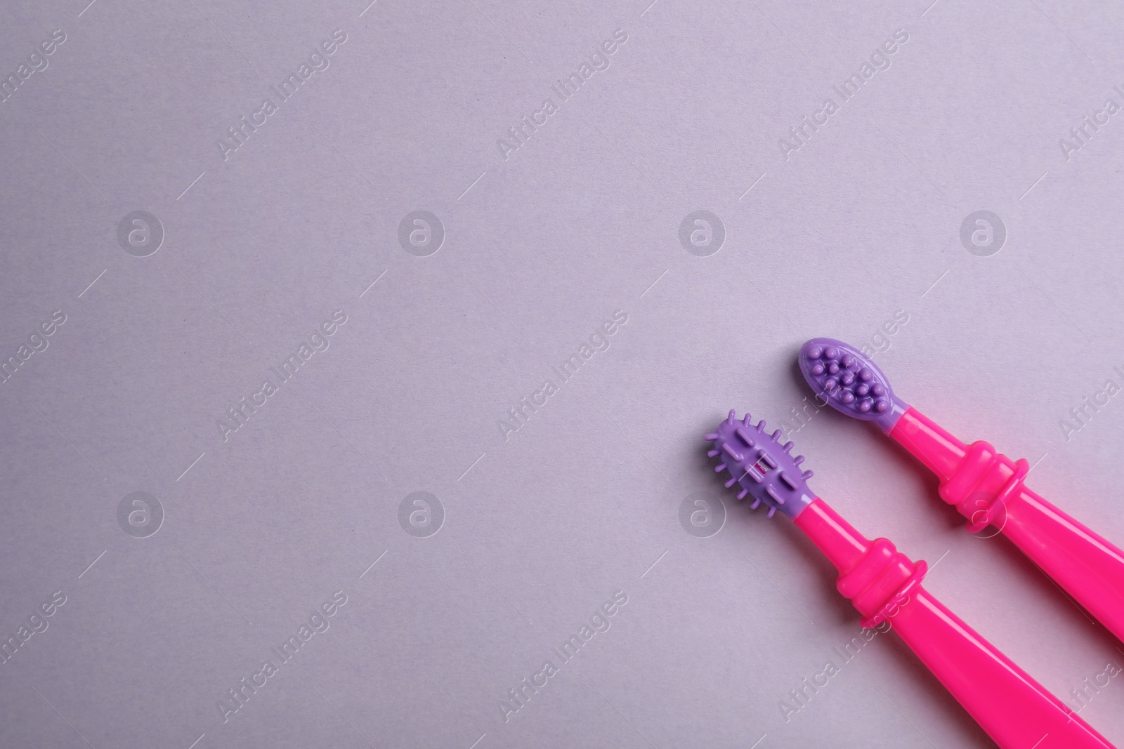 Photo of Manual toothbrushes for children on color background, top view with space for text