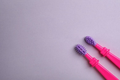 Photo of Manual toothbrushes for children on color background, top view with space for text