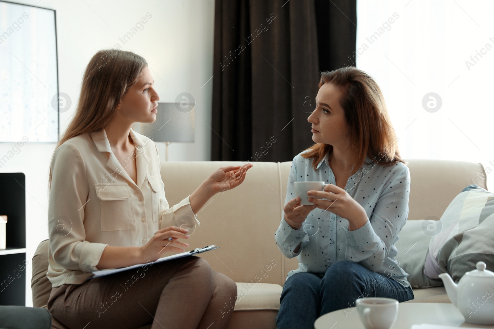 Photo of Professional psychotherapist working with patient in office