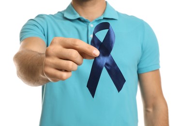 Man with blue ribbon on white background, closeup. Urology cancer awareness