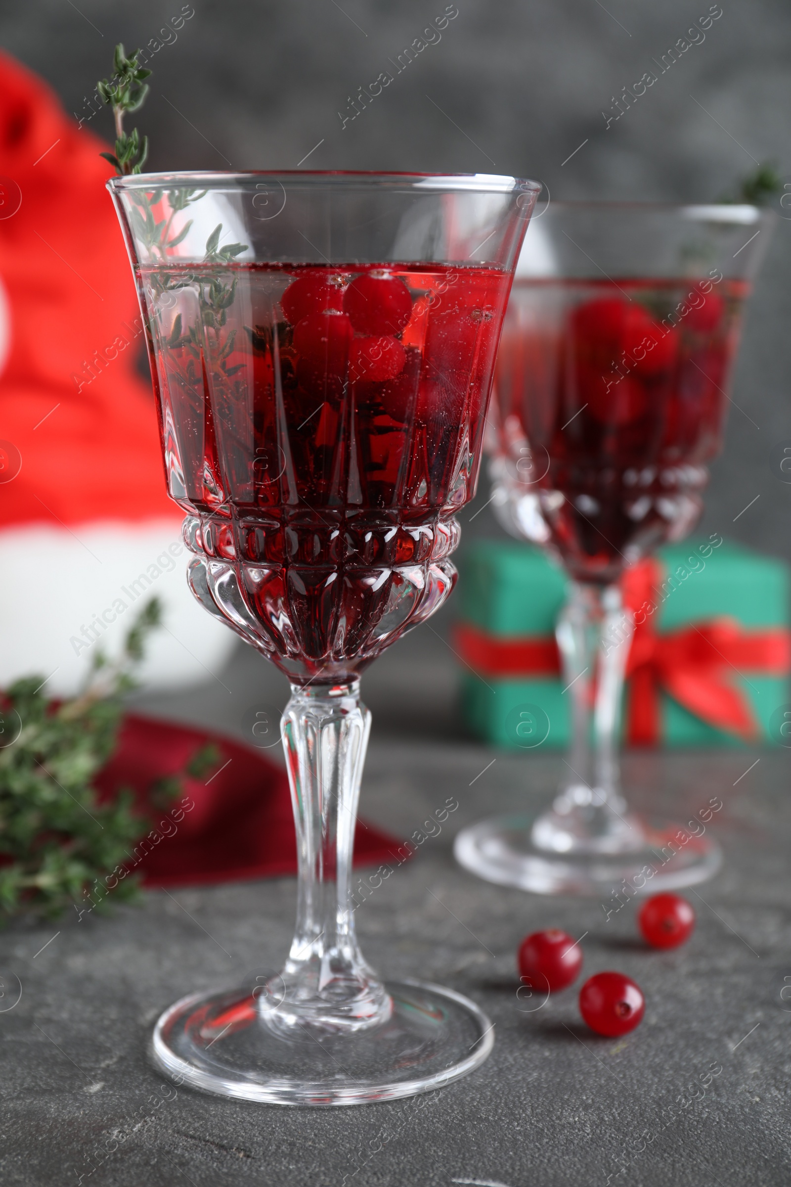 Photo of Delicious Christmas cocktail with liqueur on grey table, closeup