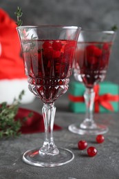 Photo of Delicious Christmas cocktail with liqueur on grey table, closeup