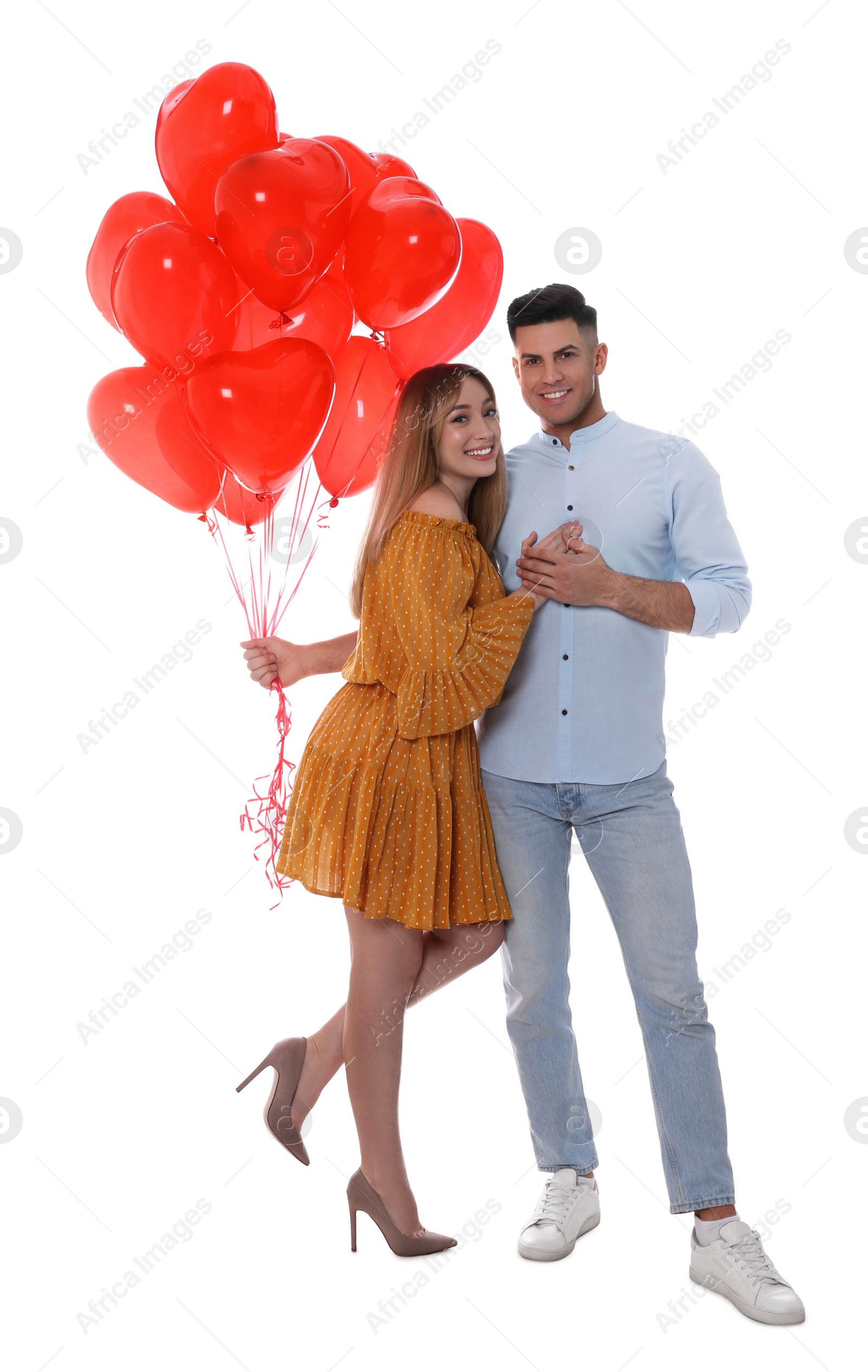 Photo of Lovely couple with heart shaped balloons on white background. Valentine's day celebration