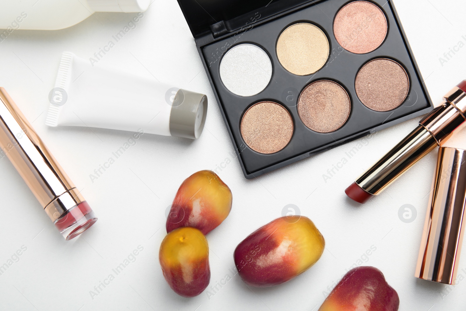 Image of Fresh ripe palm oil fruits and cosmetic products on white background, flat lay