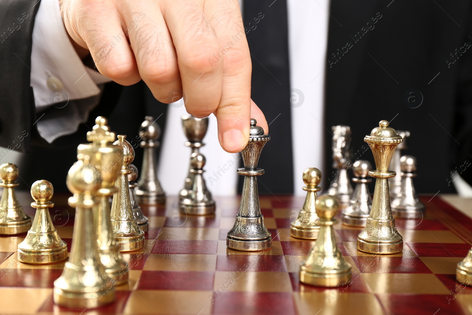 Photo of Man moving chess piece on board, closeup