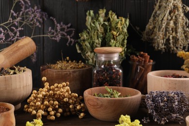 Photo of Many different dry herbs and flowers on table