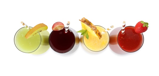 Photo of Delicious juices in glasses on white background, top view