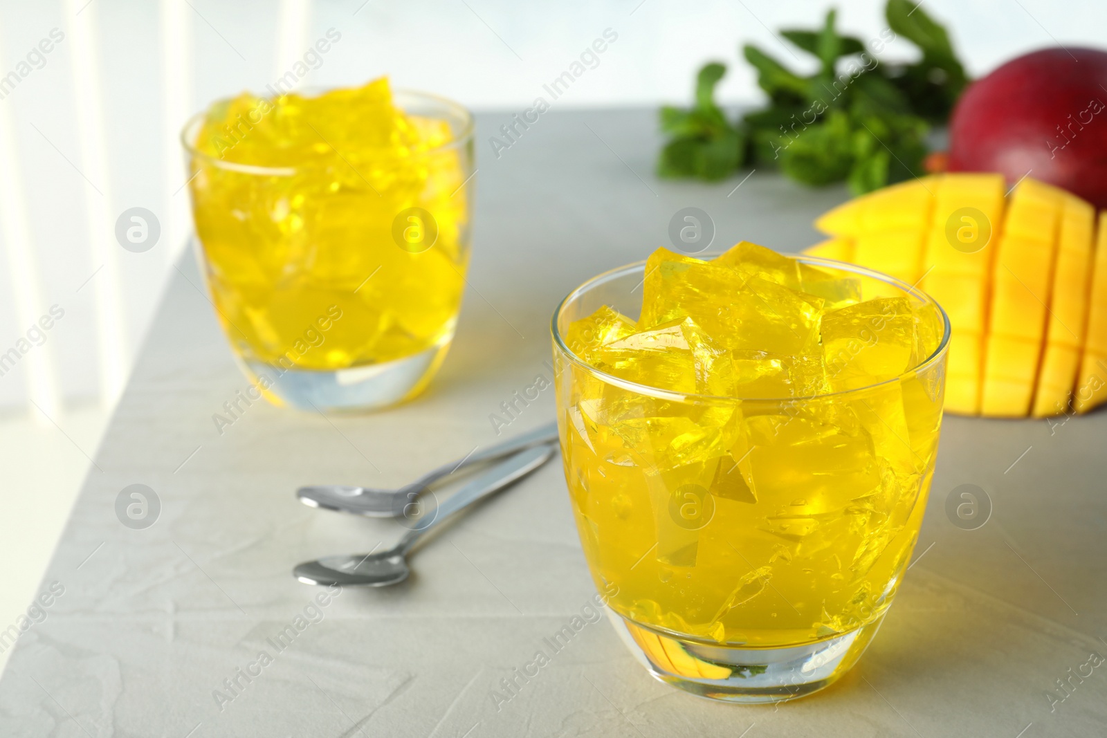 Photo of Composition with mango jelly in glass on  table. Space for text