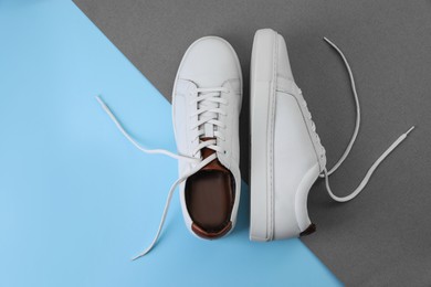 Photo of Pair of stylish sports shoes on color background, flat lay