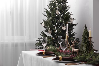 Beautiful table setting with Christmas decor in room, space for text