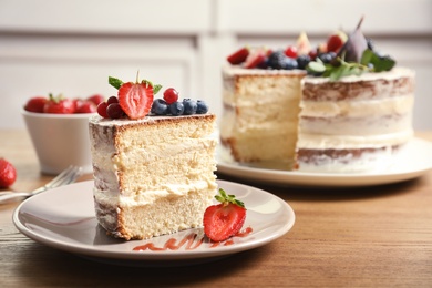 Photo of Piece of delicious homemade cake with fresh berries served on wooden table