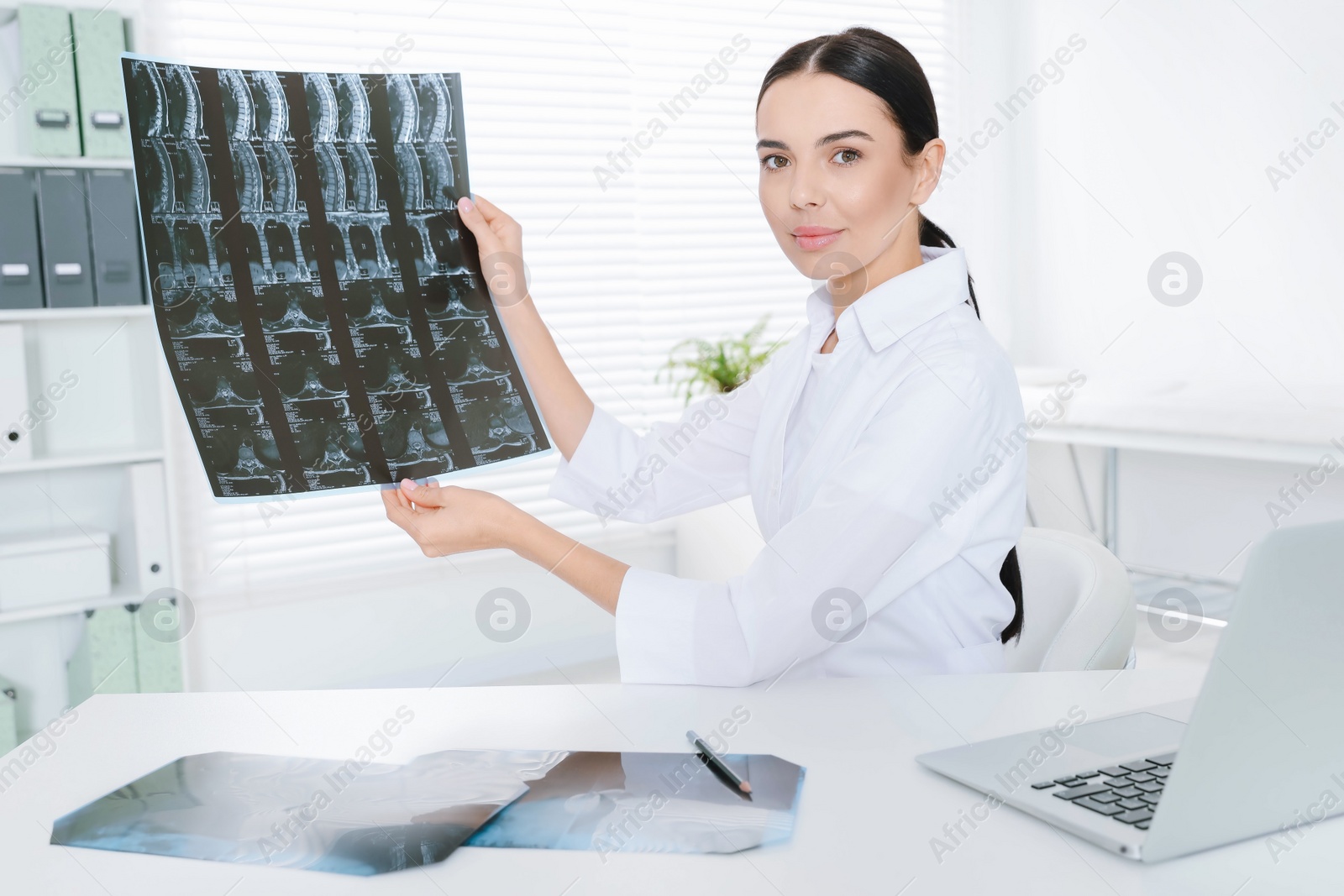 Photo of Doctor examining neck MRI image in clinic