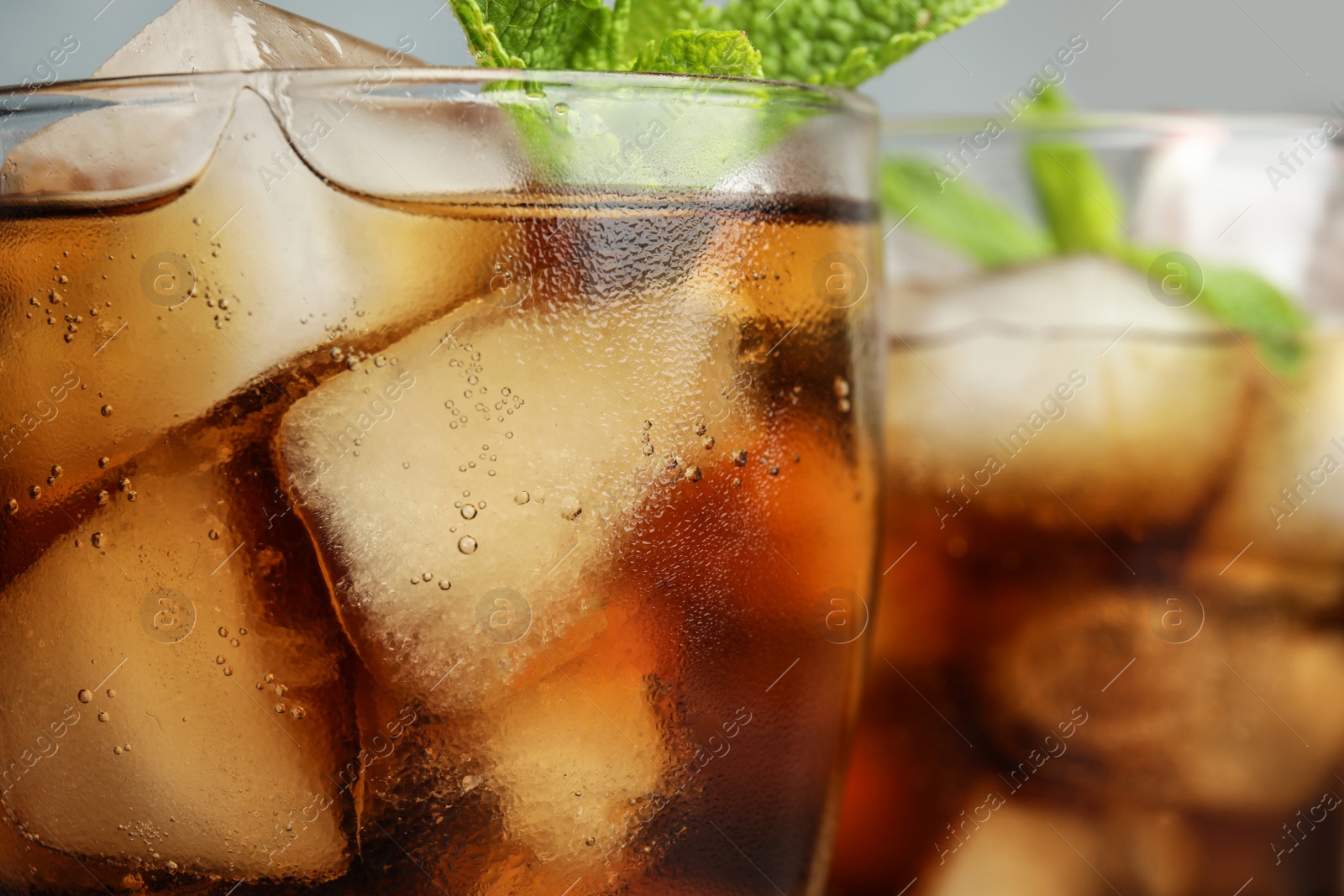 Photo of Glasses of refreshing soda drinks with ice cubes, closeup