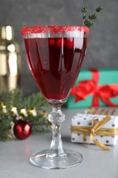 Photo of Delicious Christmas cocktail with liqueur on light table, closeup