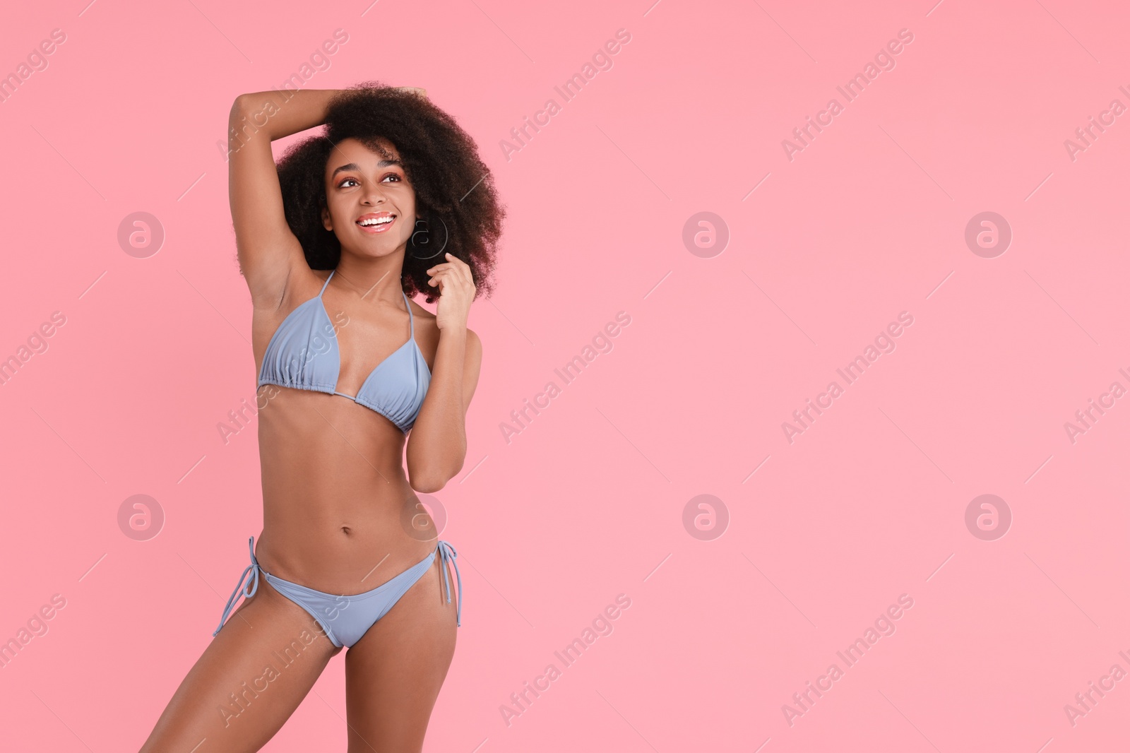 Photo of Beautiful woman in stylish bikini on pink background, space for text