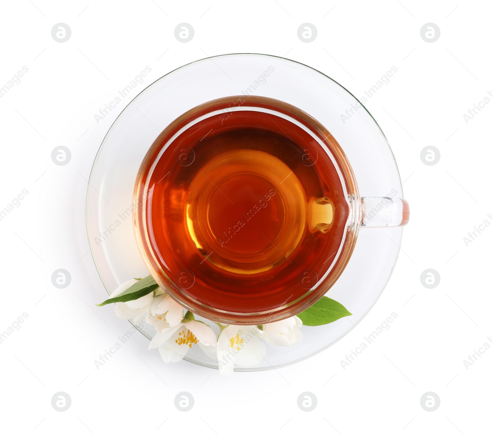 Photo of Glass cup of aromatic jasmine tea and fresh flowers on white background, top view