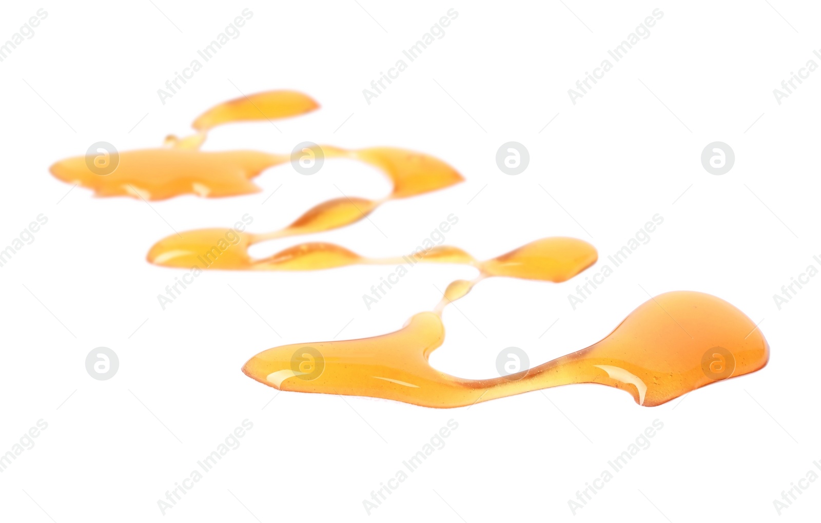 Photo of Drops of sweet honey on white background