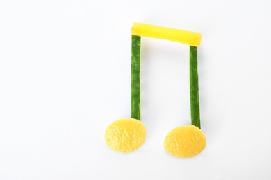 Musical note made of vegetables and fruits on white background, top view