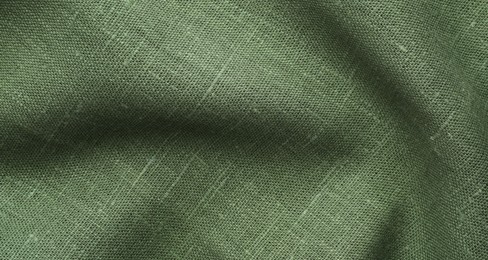 Photo of Texture of green crumpled fabric as background, top view