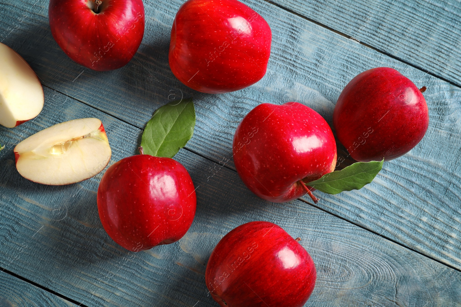 Photo of Ripe red apples on wooden background