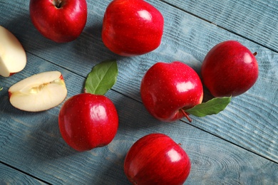 Ripe red apples on wooden background