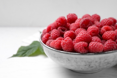 Photo of Delicious fresh ripe raspberries on white wooden table, closeup