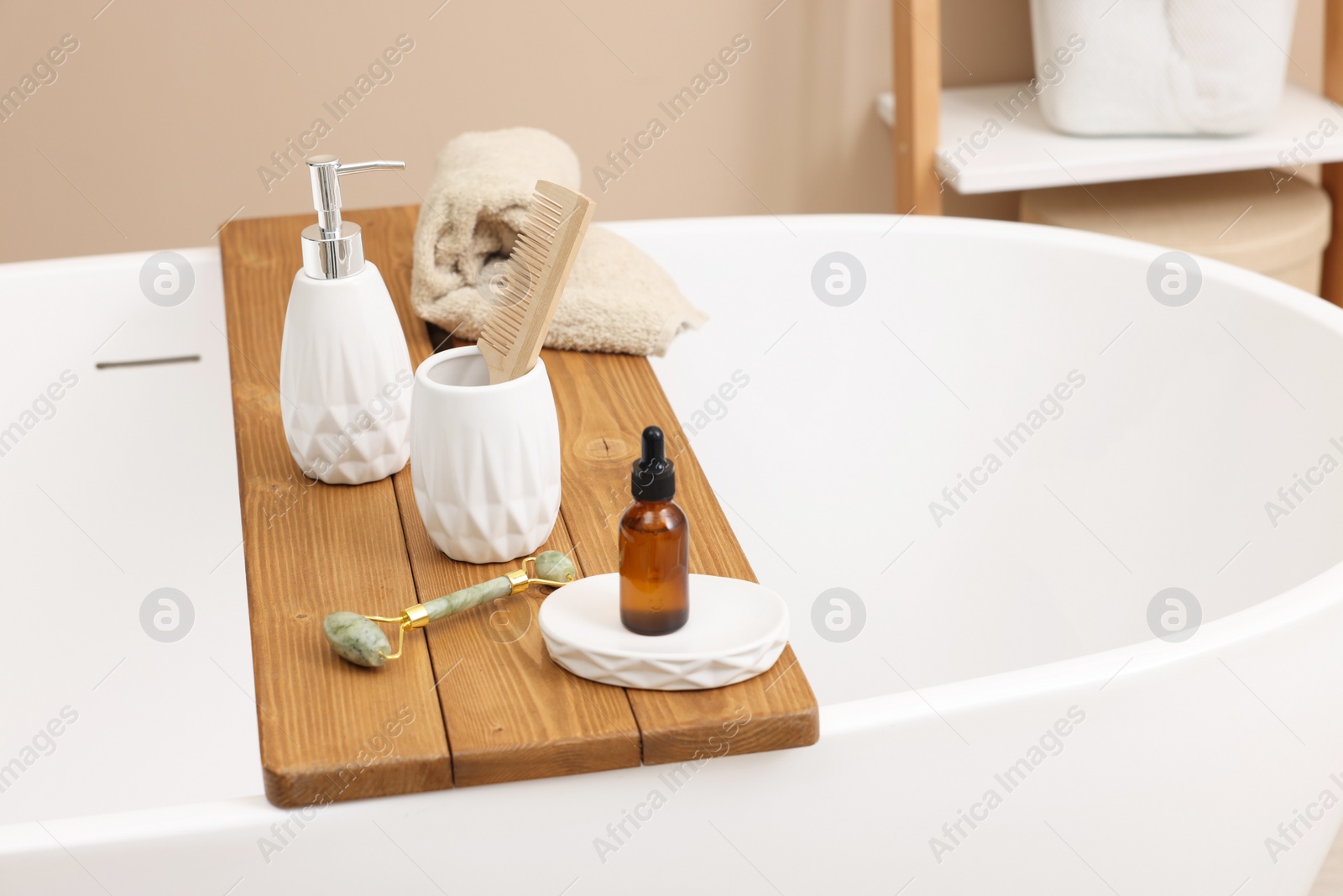 Photo of Different personal care products and accessories on bath tub in bathroom, space for text