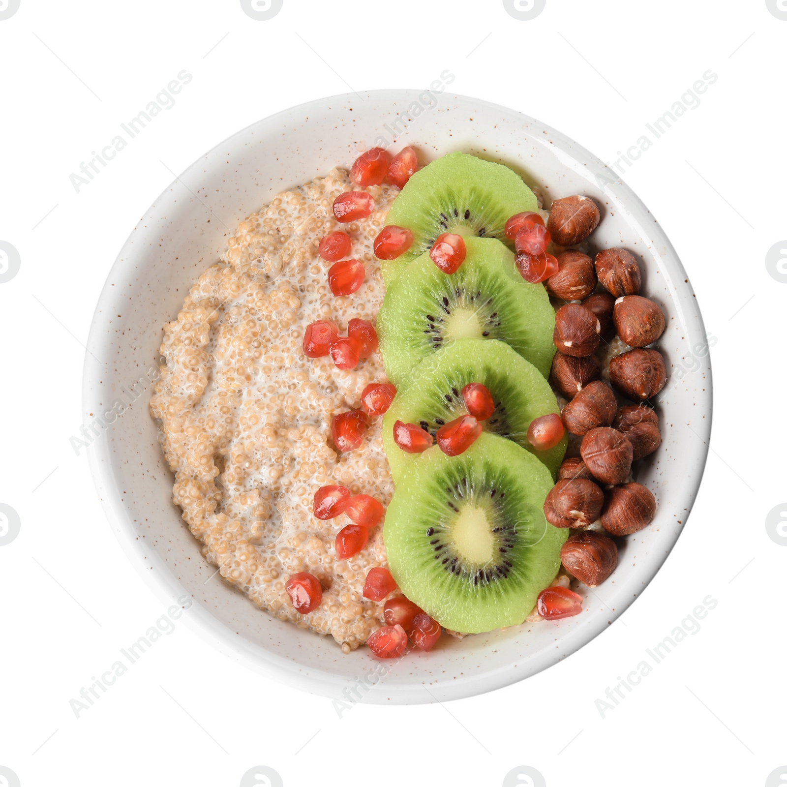 Photo of Bowl of quinoa porridge with hazelnuts, kiwi and pomegranate seeds on white background, top view