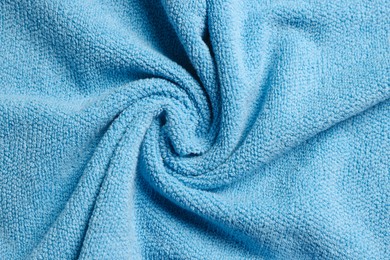Photo of Soft crumpled blue towel as background, top view