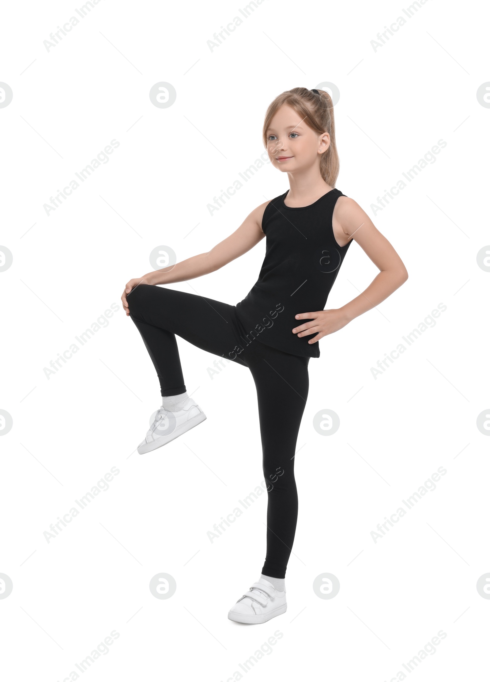 Photo of Little girl doing morning exercise on white background