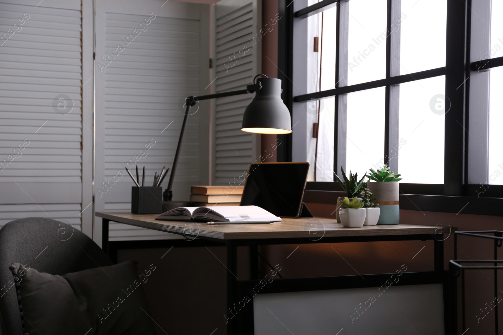 Photo of Stylish room interior with comfortable workplace near window