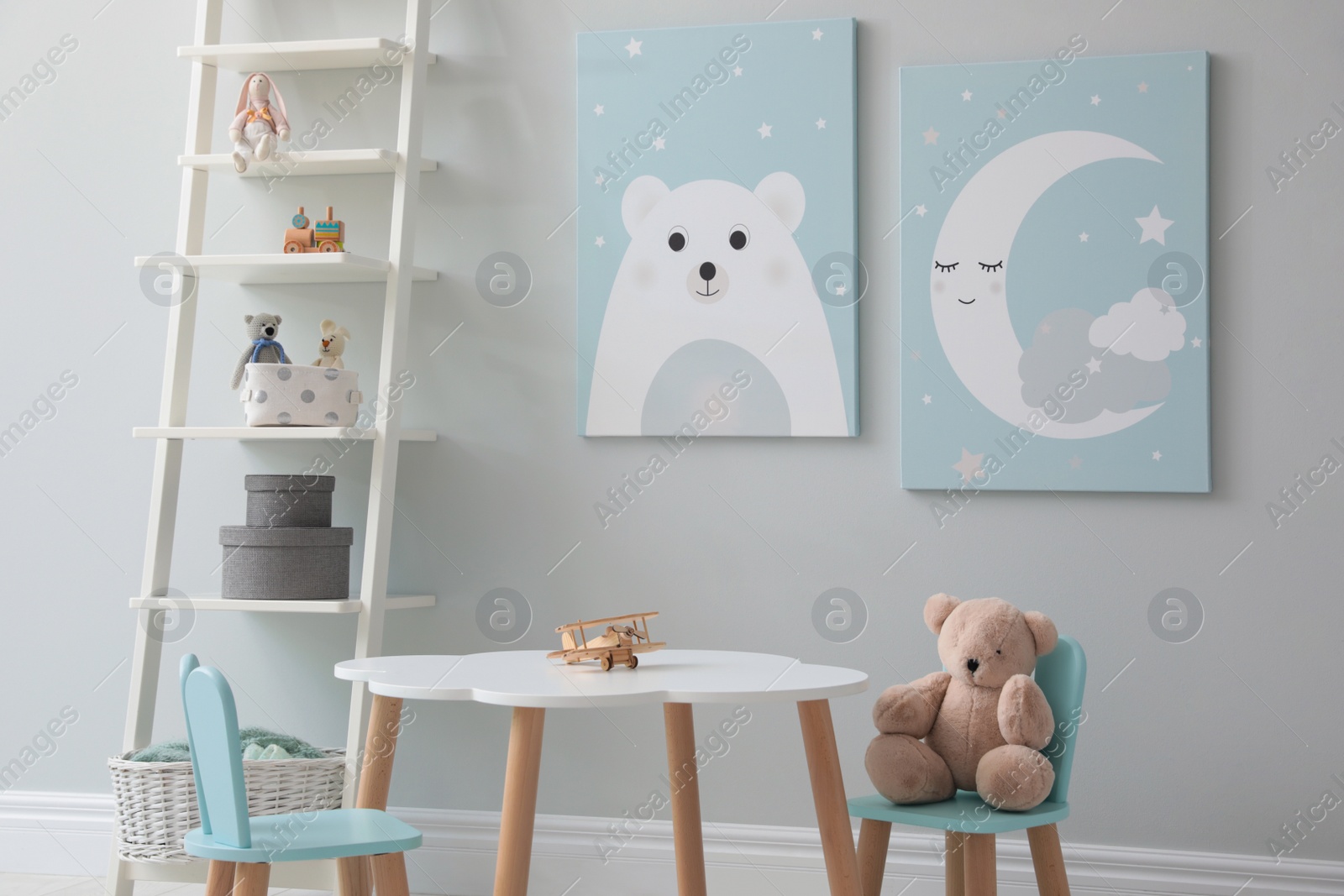 Photo of Children's room interior with table and cute pictures on wall