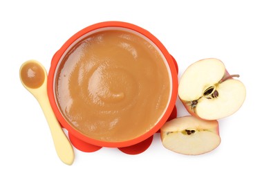 Photo of Tasty baby food in bowl, spoon and cut apple isolated on white, top view
