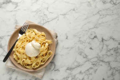 Photo of Delicious pasta with burrata cheese on white marble table, top view. Space for text