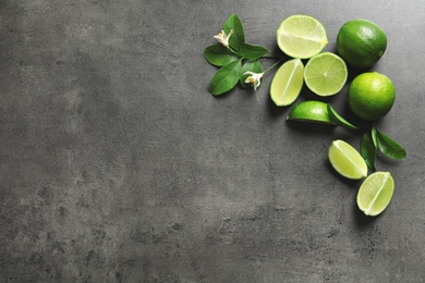 Photo of Composition with fresh ripe limes on gray background, top view