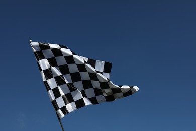 Photo of One checkered flag against blue sky outdoors, low angle view and space for text