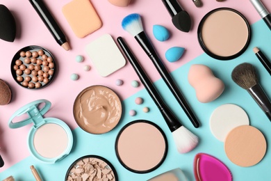 Photo of Flat lay composition with skin foundation, powder and beauty accessories on color background