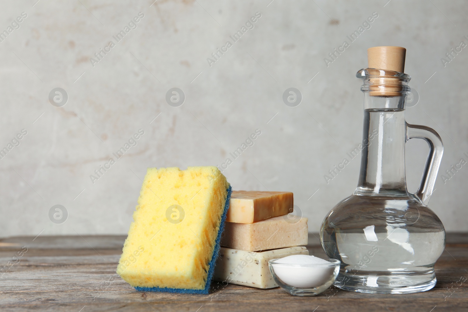 Photo of Composition with vinegar and cleaning supplies on table