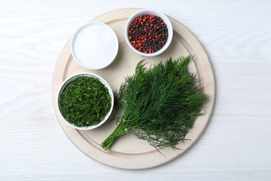 Photo of Fresh dill, sour cream and spices on white wooden table, top view