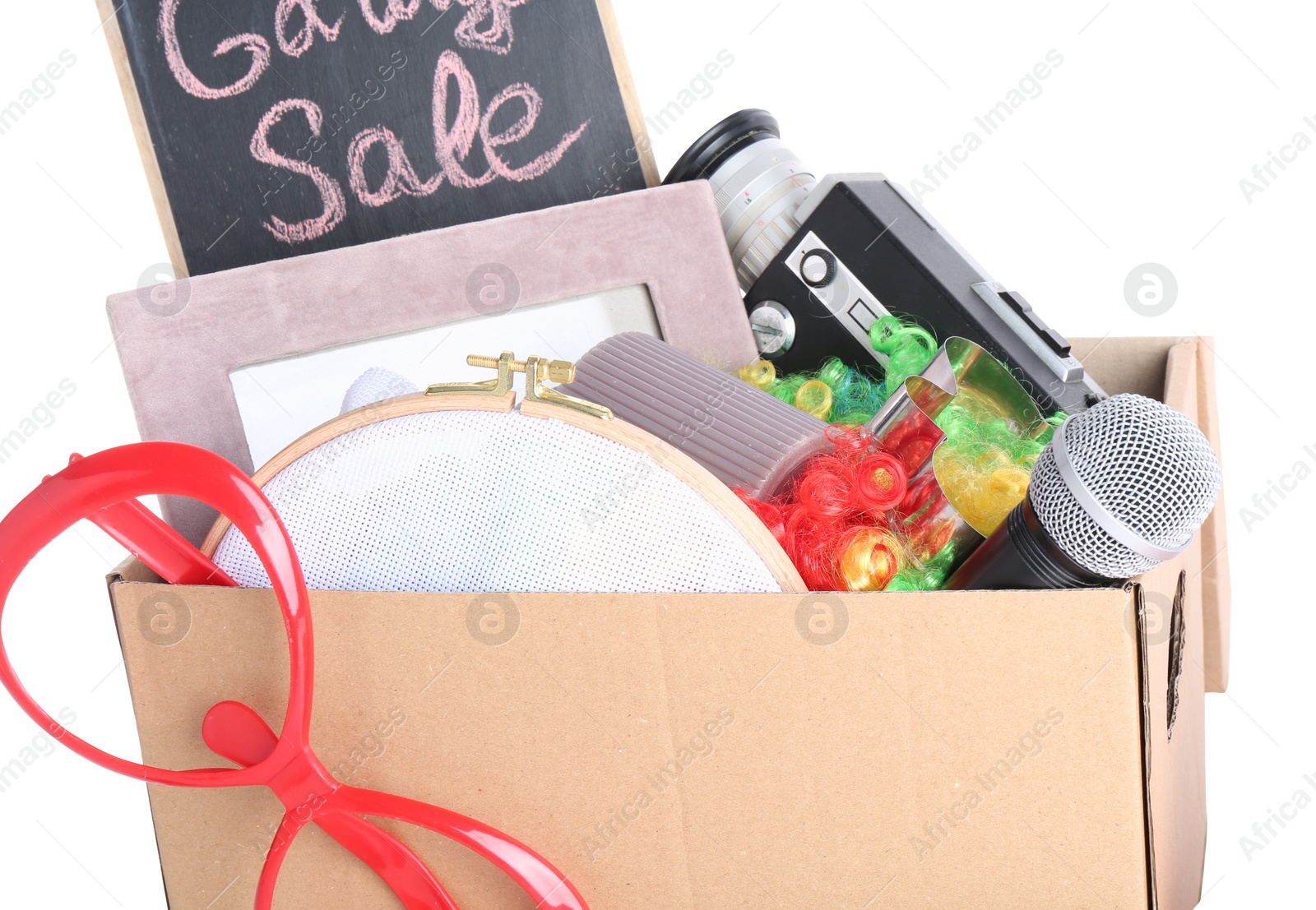 Photo of Box of unwanted stuff isolated on white. Garage sale