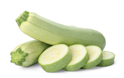 Photo of Cut and whole green ripe zucchinis on white background